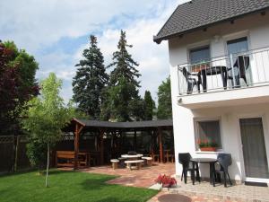 a patio of a house with a table and chairs at Csilla apartman in Hajdúszoboszló