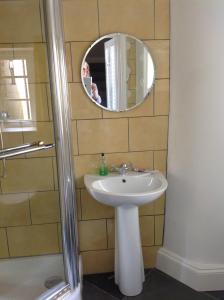 a bathroom with a sink and a mirror at 6 Hill Street, Haverfordwest. in Pembrokeshire +3 photos