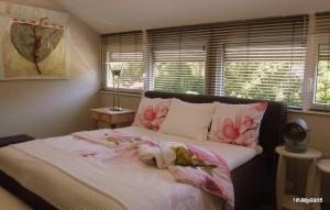 a bedroom with a bed with pink flowers on it at Bed and Breakfast Valckenbosch in Zeist