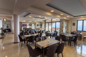 a restaurant with tables and chairs in a room at Dimitra's Resorts in Vlóngos