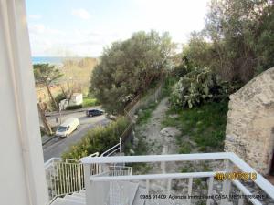 een balkon met uitzicht op een weg en de oceaan bij Mare Apartment 4 in Scalea