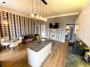 a kitchen and living room with a couch and a table at The Waterhouse at Claremont Apartments in Leeds