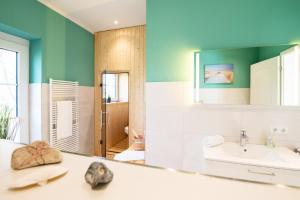a bathroom with a sink and a mirror at Fehmarn Mein Urlaub in Fehmarn +14 photos