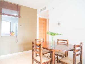 a dining room with a wooden table and chairs at Apartamentos Doña Maria in Alcossebre