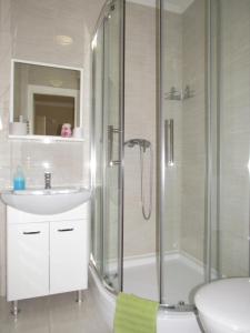 a bathroom with a shower and a sink and a toilet at Csilla apartman in Hajdúszoboszló +44 photos