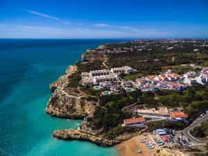 an aerial view of a village on the edge of a cliff at House located in opposite of beach! in Lagoa