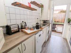 a kitchen with white appliances and a counter top at Teàrlach House in Alnwick