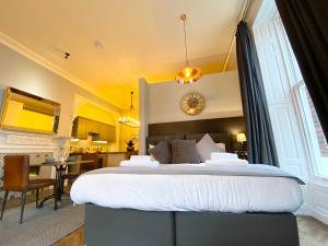 a bedroom with a large bed in a room at The Deakin at Claremont Serviced Apartments in Leeds