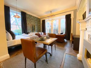 The Deakin at Claremont Serviced Apartments في ليدز: غرفة معيشة مع طاولة طعام وغرفة معيشة