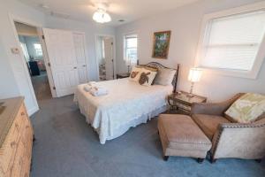 a bedroom with a bed and a chair and a couch at BEACH FRONT!!! Steps from the Beach - Fantastic Views in Harbor Island