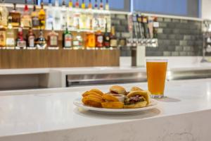 a plate of food on a counter with a glass of beer at Holiday Inn Portland West - Hillsboro, an IHG hotel in Hillsboro