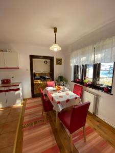 a kitchen and dining room with a table and chairs at SIM House & Barn in Săcele