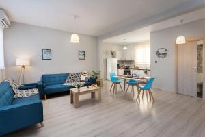 a living room with a blue couch and a table at Premium Homes by Athens Stay in Athens