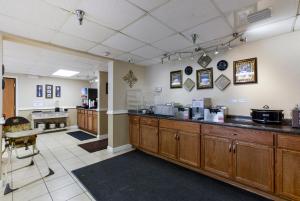 a large kitchen with wooden cabinets and a counter at Grand View Inn & Suites in Branson