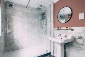 a bathroom with a shower and a sink and a mirror at Weavers Guesthouse by Weavers of Haworth in Haworth +93 photos