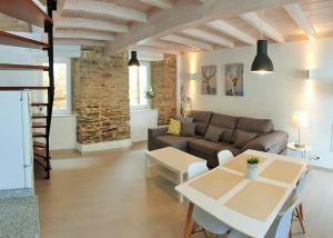a living room with a couch and a table at Apartagal-Casas de Portochico, Foz in Foz