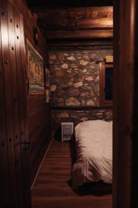 a small room with a bed in a log cabin at Kleio in Elatochori