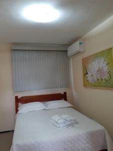 a bedroom with a bed with two towels on it at Apto. 100m da feirinha da beira mar in Fortaleza