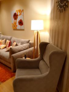 a living room with a couch and a lamp at Apartman Lukić in Zlatibor