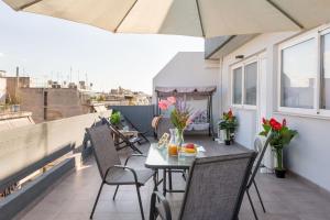 a patio with a table and chairs on a balcony at Premium Homes by Athens Stay in Athens