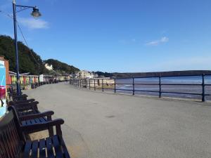 a row of benches sitting next to the ocean at Heart of Filey in Filey