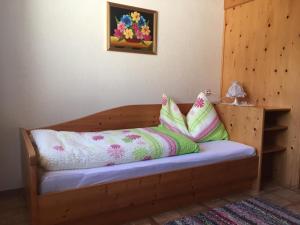 a wooden bench with pillows on it in a room at Mitterbergerhof in Wiesen