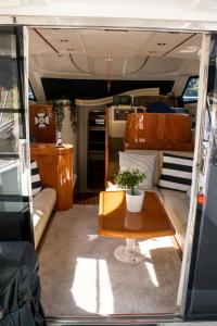 a living room with a table and a couch at AQUADOURO Yacht RADAMES - Sleep Boat Experience in Castelo de Paiva