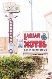 a sign for a morden motel on a street at Larian Motel in Tombstone