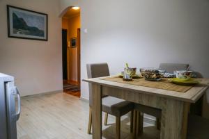 a dining room with a table with chairs at Lagumska in Zemun