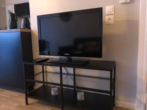 a flat screen tv sitting on a black stand at happiness Disney in Saint-Germain-sur-Morin