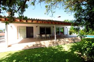 a home with a patio with a table and chairs at Mallorca Villa Bon Aire Son Bernat in Llubí