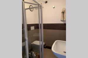 a bathroom with a shower and a toilet and a sink at A 2 minuti dalle piste da sci e campo da golf. in Sestriere