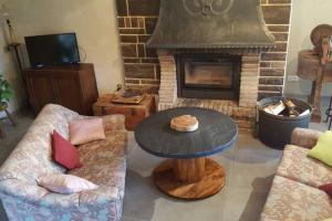 a living room with a table and a fireplace at Maison Rochefort quartier Montrival in Rochefort