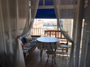a room with a table and chairs and a balcony at Marina in Gandía