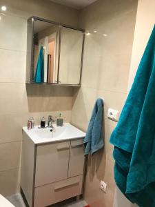 a bathroom with a sink and a blue towel at Marina in Gandía