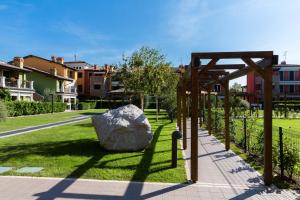 a large rock sitting on the grass in a park at Appartamento Essenza in Sirmione