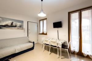 a bedroom with a bed and a table and chairs at Lucy in Sirmione