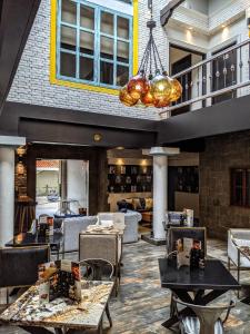 a restaurant with tables and chairs and a chandelier at Cedros Inn Boutique Hotel in Guayaquil