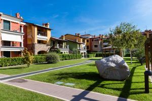 a large rock sitting in the middle of a park at Appartamento Corina in Sirmione