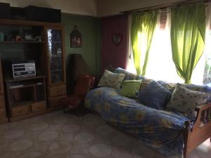 a living room with a couch and a window at Hostel Casa & Campo in Buenos Aires