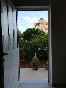 an open door with a view of a house at Art Apartments in Ksamil