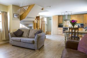 a living room with a couch and a staircase at Finest Retreats - 2 Bed Llangollen Cottage - Sleeps 4 in Llangollen