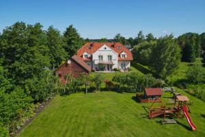 an aerial view of a house on a hill at Dworek Pod Różą in Karwieńskie Błoto Pierwsze