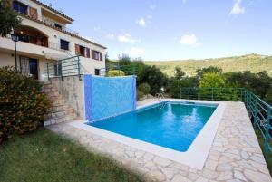 a swimming pool in front of a house at Club Villamar - Sport in Calonge