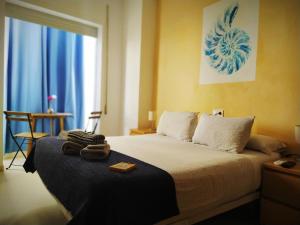 Posteľ alebo postele v izbe v ubytovaní Hostal Casa Nautilus