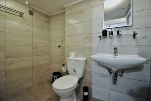 a bathroom with a toilet and a sink at Suite Tic by Be My Guest in Athens
