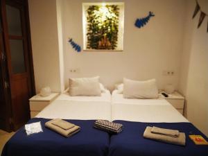 Posteľ alebo postele v izbe v ubytovaní Hostal Casa Nautilus
