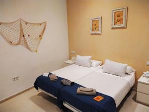 Posteľ alebo postele v izbe v ubytovaní Hostal Casa Nautilus