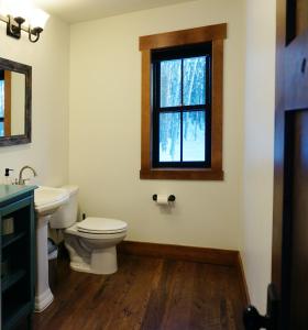 a bathroom with a toilet and a window at Silver Birch Vacation Rental in Talkeetna +13 photos