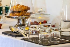 a table with a tray of pastries and a glass dish at Dodford Grange in Daventry